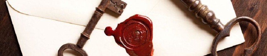 Old key on top of the back of an envelope with a red seal